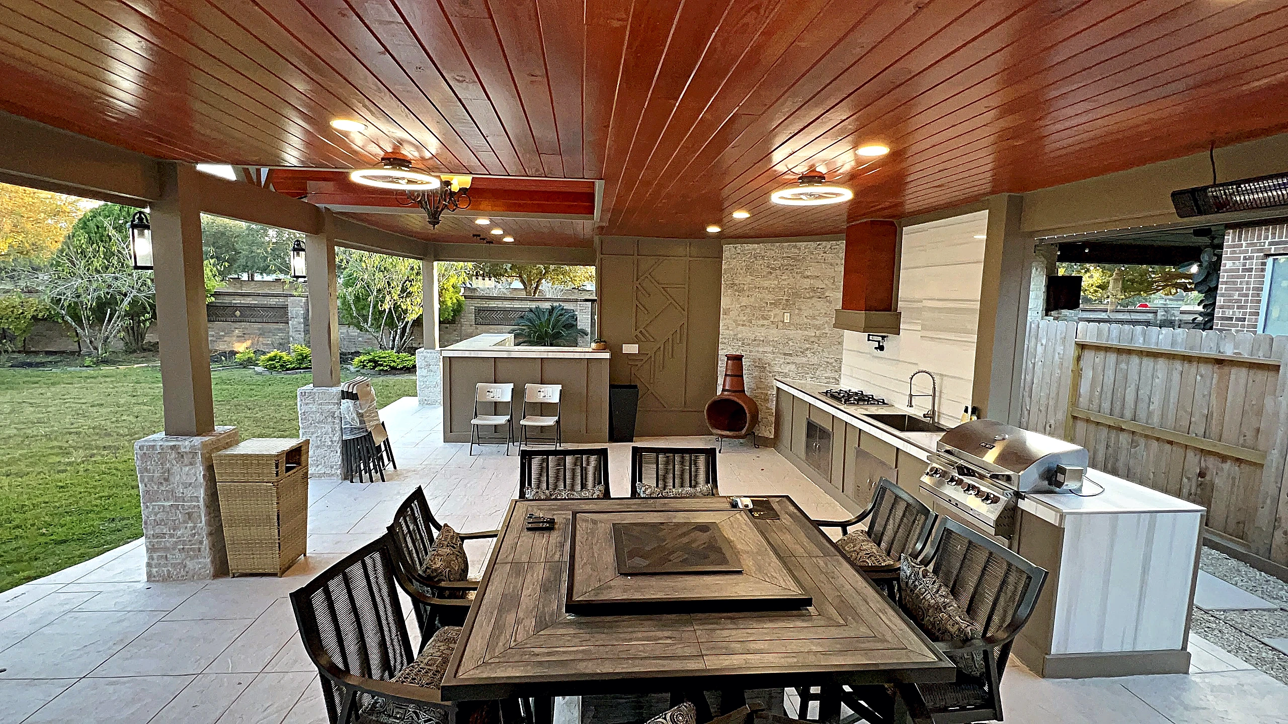 Finished covered outdoor kitchen and dining pavilion extending the living area of a Cinco Ranch home into the backyard.