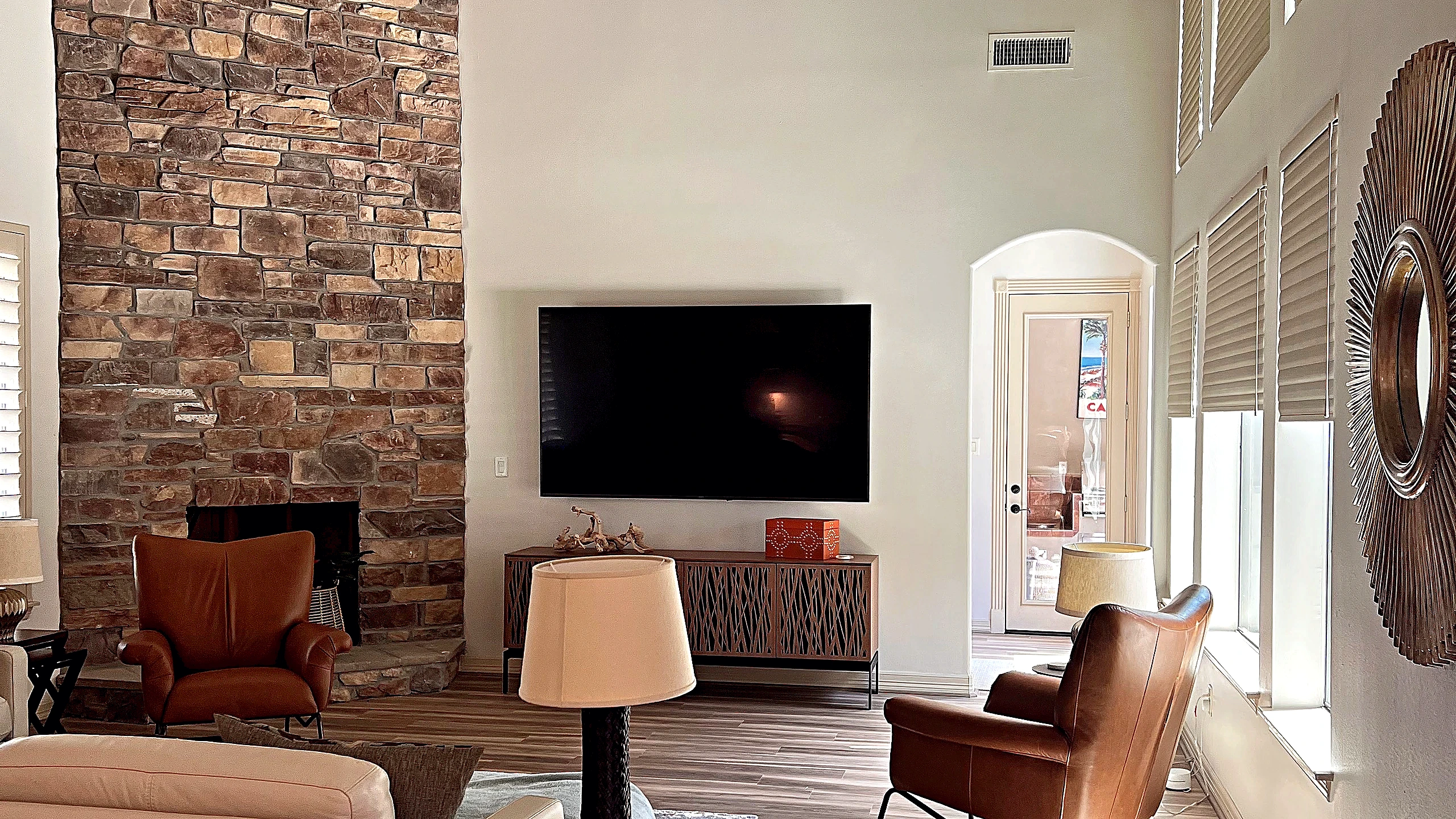 White perimeter cabinetry with stainless range hood and open wood shelving in Tomball remodel