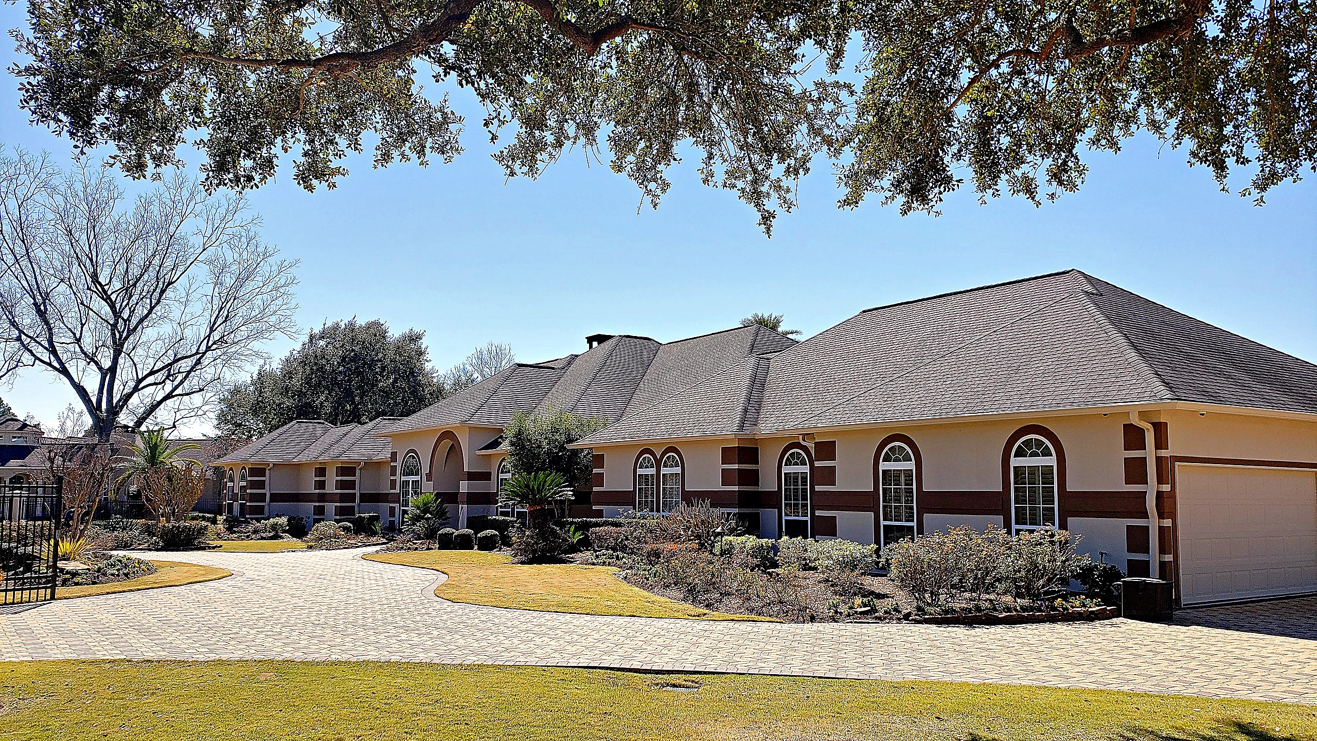 Tomball estate fully renovated by Bager Remodeling — gated masonry entry, stamped concrete driveway, and finished interior si