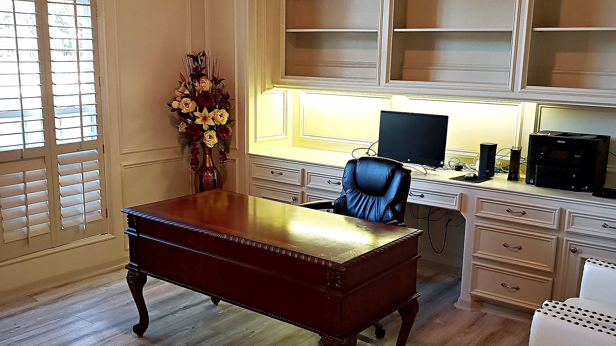 Plantation shutters and panel wall molding detail in the finished sitting room of a Tomball, Texas home renovation